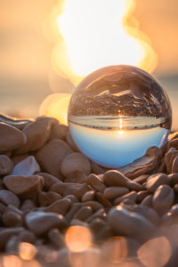 crystal ball on the pebble beach of Mošćenička Draga at sunrise, Primorje-Gorski Kotar County, Croatia crystal ball on the pebble beach of Mošćenička Draga at sunrise, Primorje-Gorski Kotar County, Croatia